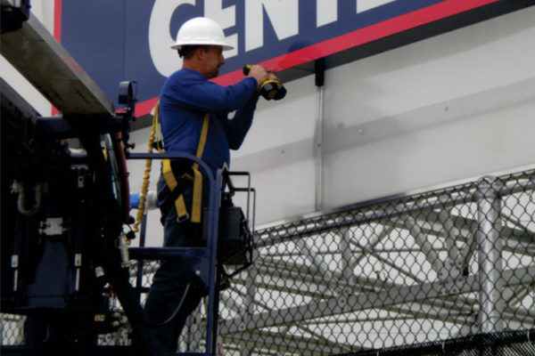 home depot garden sign, man in bucket truck performing sign maintenance